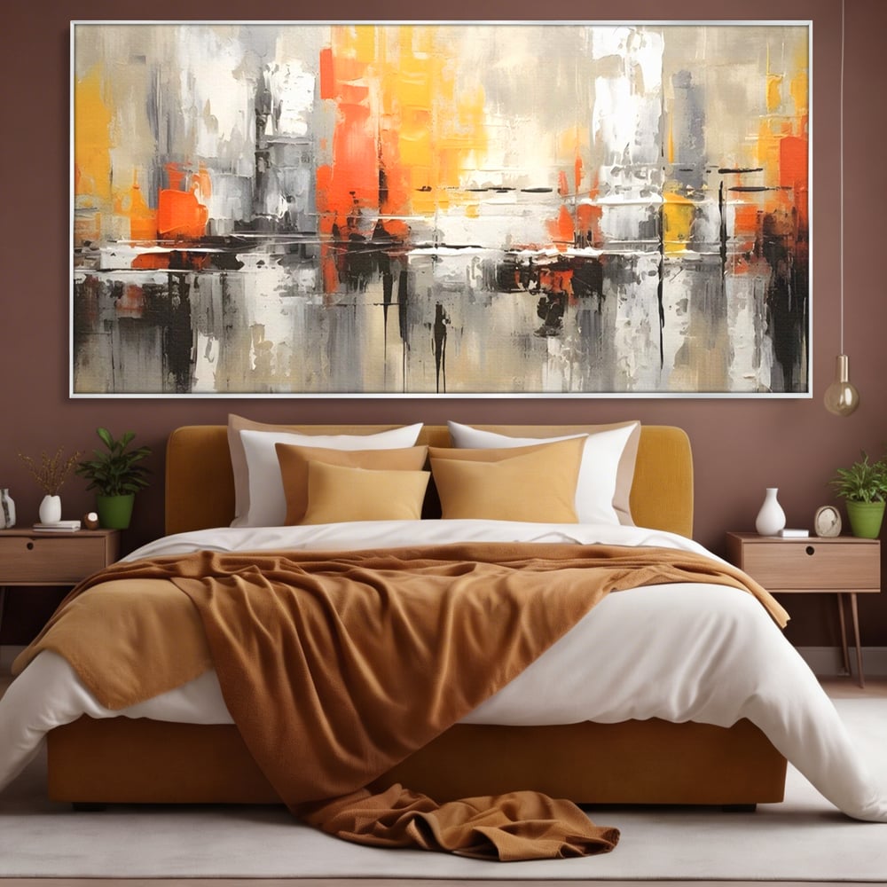 Tablou canvas cu pictura abstracta cu turnuri portocalii, in rama de aluminiu argintiu, pe perete intr-un dormitor